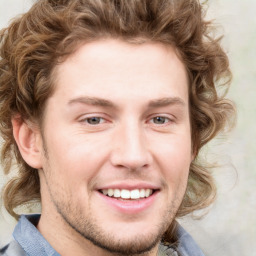 Joyful white young-adult male with short  brown hair and blue eyes