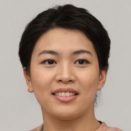 Joyful asian young-adult female with short  black hair and brown eyes