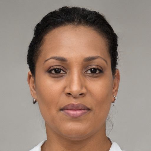 Joyful latino adult female with short  brown hair and brown eyes
