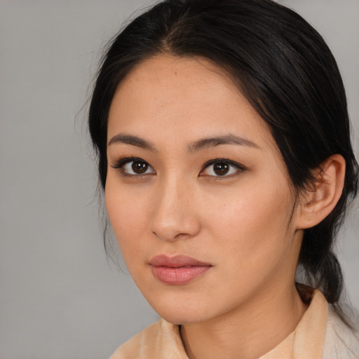 Joyful asian young-adult female with medium  brown hair and brown eyes