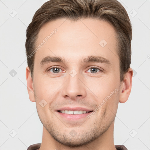 Joyful white young-adult male with short  brown hair and grey eyes