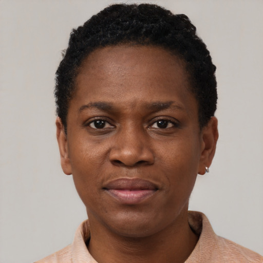 Joyful black adult female with short  black hair and brown eyes