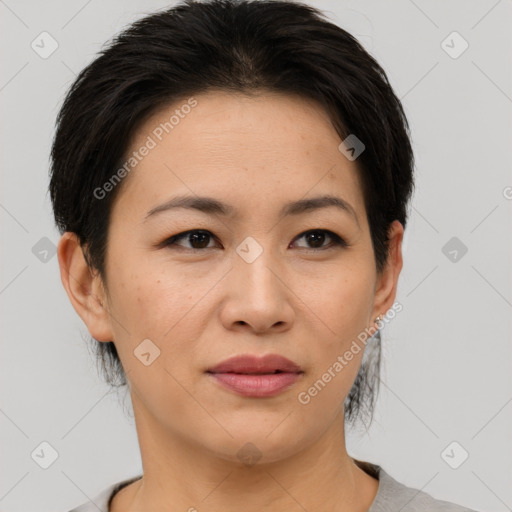 Joyful asian young-adult female with short  brown hair and brown eyes