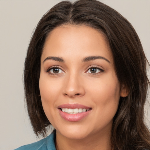 Joyful white young-adult female with long  brown hair and brown eyes