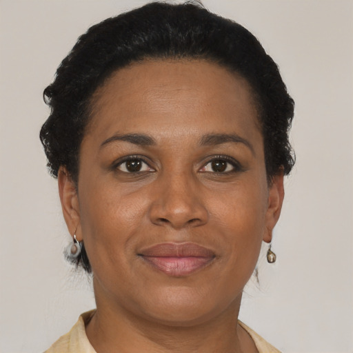 Joyful black adult female with short  brown hair and brown eyes