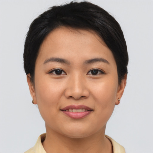 Joyful asian young-adult female with short  brown hair and brown eyes