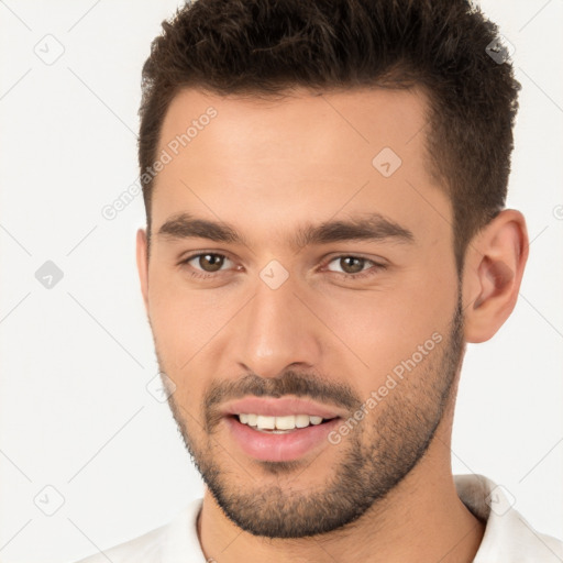 Joyful white young-adult male with short  brown hair and brown eyes