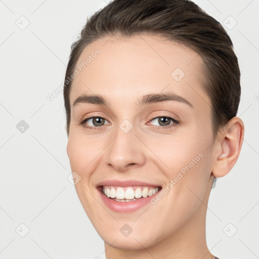 Joyful white young-adult female with medium  brown hair and brown eyes