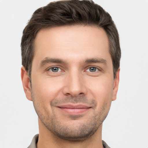 Joyful white young-adult male with short  brown hair and brown eyes