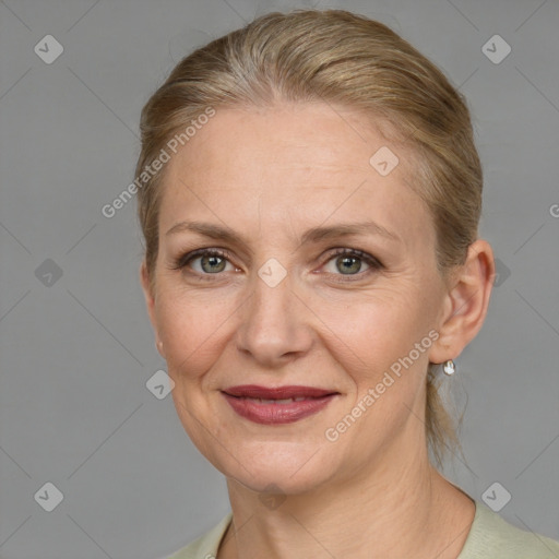 Joyful white adult female with medium  brown hair and grey eyes