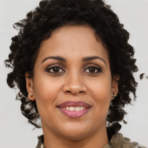 Joyful black young-adult female with medium  brown hair and brown eyes