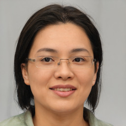 Joyful asian young-adult female with medium  brown hair and brown eyes