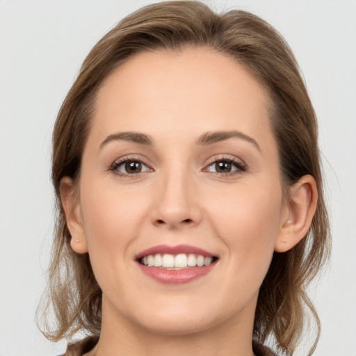 Joyful white young-adult female with long  brown hair and grey eyes