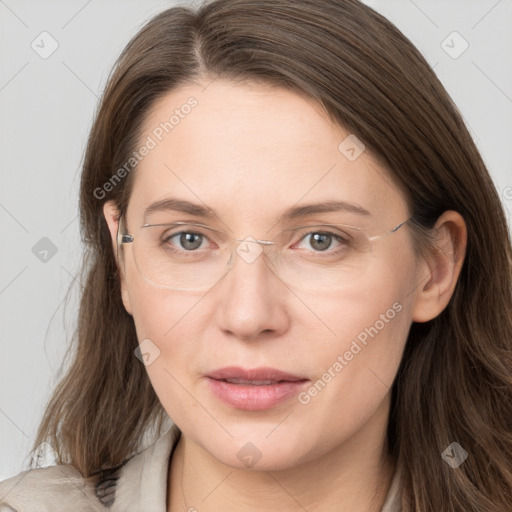 Joyful white adult female with long  brown hair and grey eyes