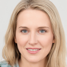 Joyful white young-adult female with long  brown hair and blue eyes