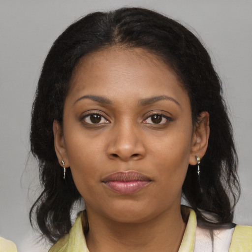 Joyful black young-adult female with medium  brown hair and brown eyes