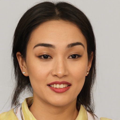 Joyful latino young-adult female with medium  brown hair and brown eyes