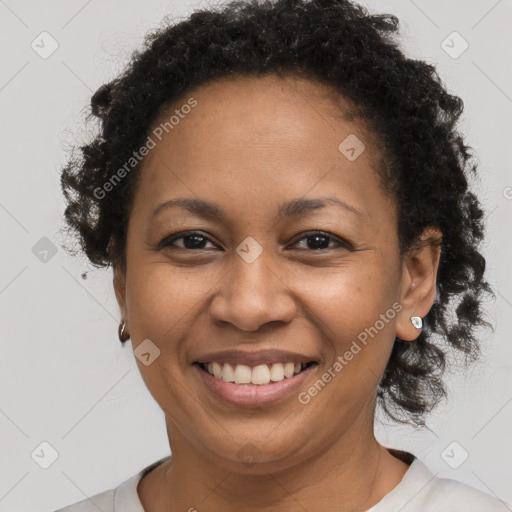 Joyful black adult female with short  brown hair and brown eyes