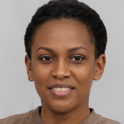 Joyful black young-adult female with short  black hair and brown eyes