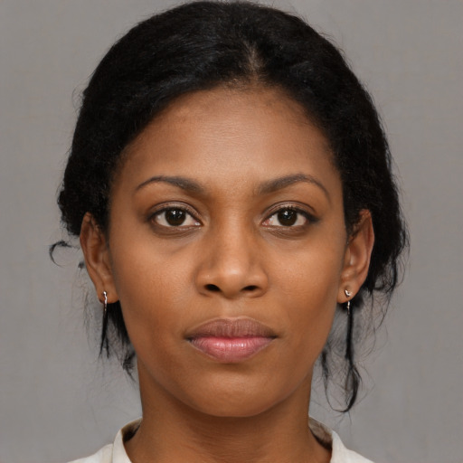 Joyful black young-adult female with medium  brown hair and brown eyes