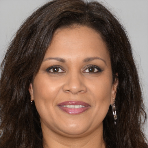 Joyful white adult female with long  brown hair and brown eyes