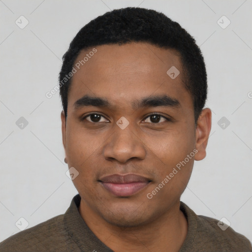 Joyful black young-adult male with short  black hair and brown eyes