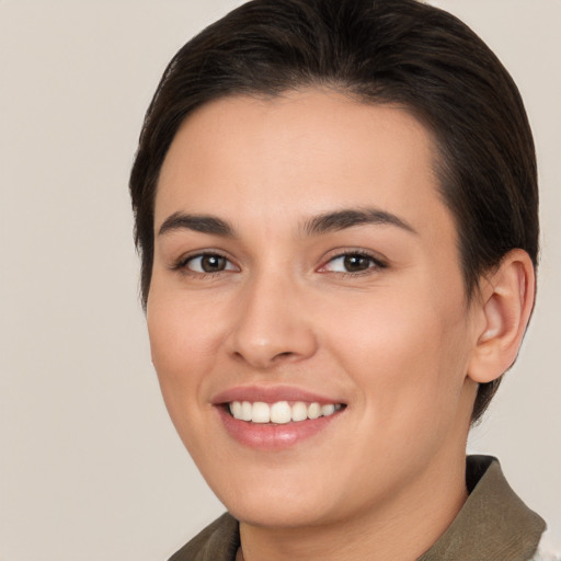 Joyful white young-adult female with short  brown hair and brown eyes