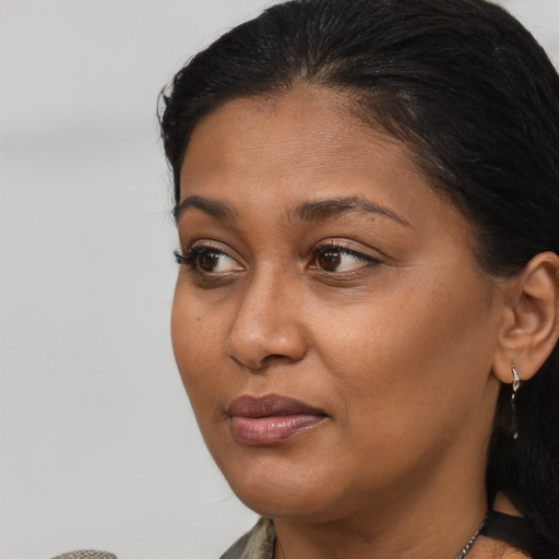 Joyful black adult female with short  brown hair and brown eyes