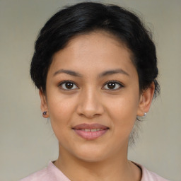 Joyful latino young-adult female with medium  brown hair and brown eyes