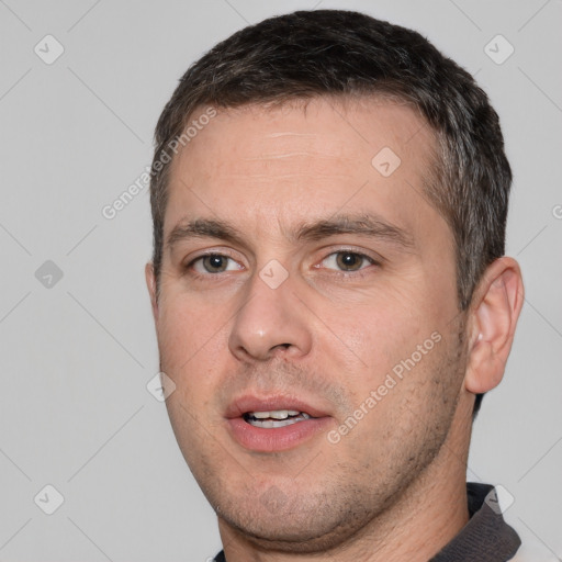 Joyful white adult male with short  brown hair and brown eyes