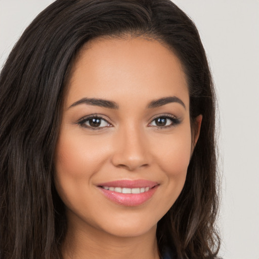 Joyful white young-adult female with long  brown hair and brown eyes