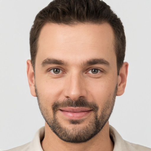 Joyful white young-adult male with short  brown hair and brown eyes