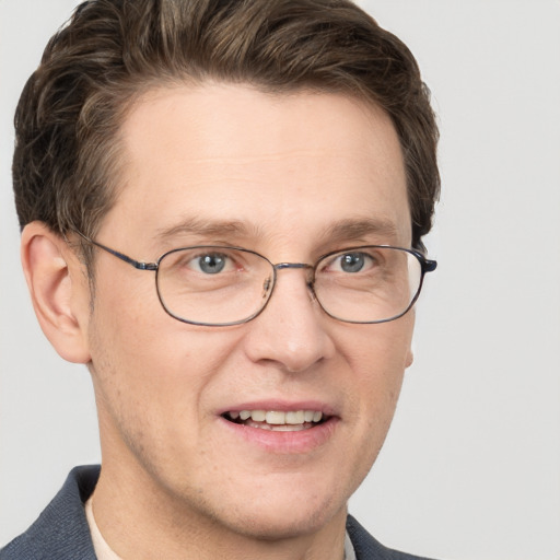 Joyful white adult male with short  brown hair and grey eyes