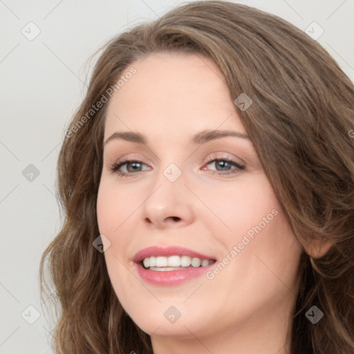 Joyful white young-adult female with long  brown hair and green eyes