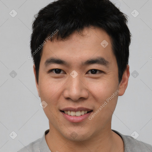 Joyful asian young-adult male with short  black hair and brown eyes