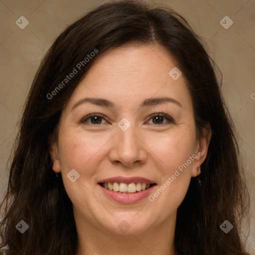 Joyful white adult female with long  brown hair and brown eyes