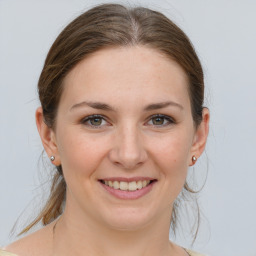 Joyful white young-adult female with medium  brown hair and grey eyes