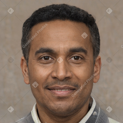 Joyful latino adult male with short  black hair and brown eyes