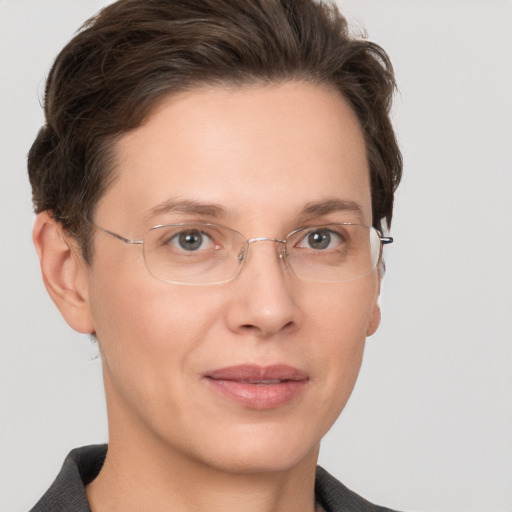 Joyful white adult female with short  brown hair and grey eyes