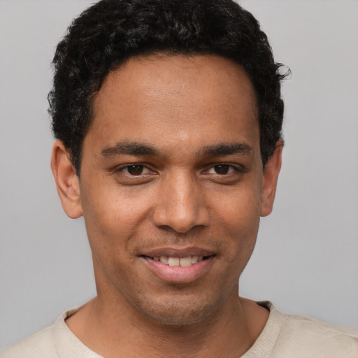 Joyful white young-adult male with short  black hair and brown eyes