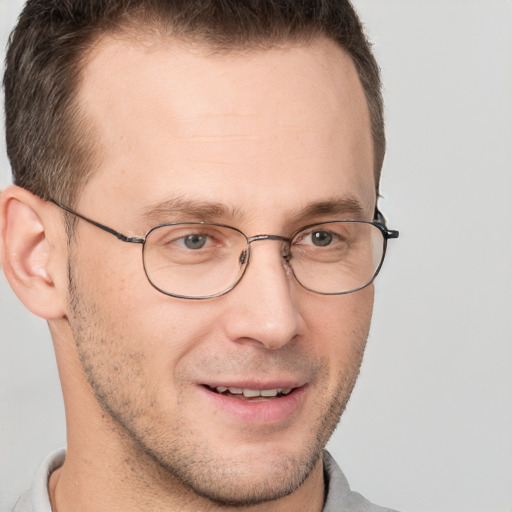 Joyful white adult male with short  brown hair and brown eyes