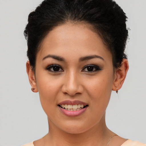 Joyful latino young-adult female with short  brown hair and brown eyes