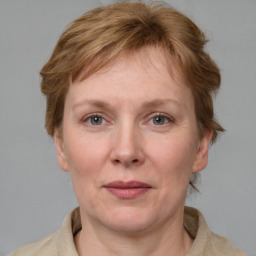Joyful white adult female with medium  brown hair and blue eyes