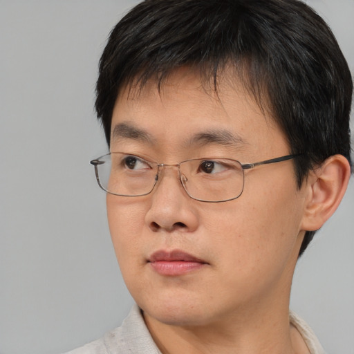 Neutral asian young-adult male with short  brown hair and brown eyes