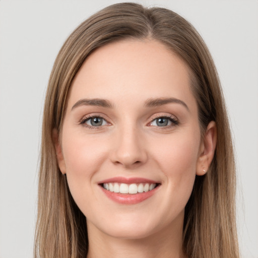 Joyful white young-adult female with long  brown hair and grey eyes