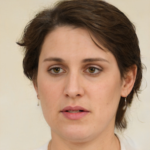 Joyful white young-adult female with medium  brown hair and green eyes