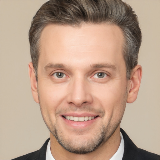 Joyful white adult male with short  brown hair and brown eyes