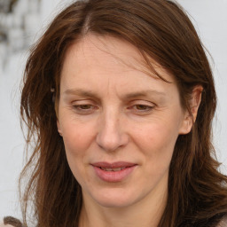 Joyful white adult female with long  brown hair and brown eyes