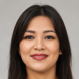 Joyful latino young-adult female with long  brown hair and brown eyes