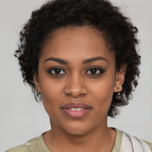 Joyful black young-adult female with short  brown hair and brown eyes